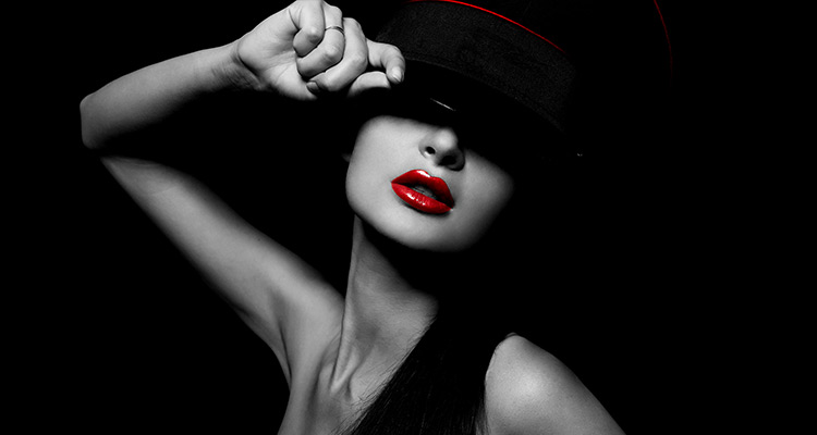 black and white portrait of a woman wearing a hat and red lipstick 